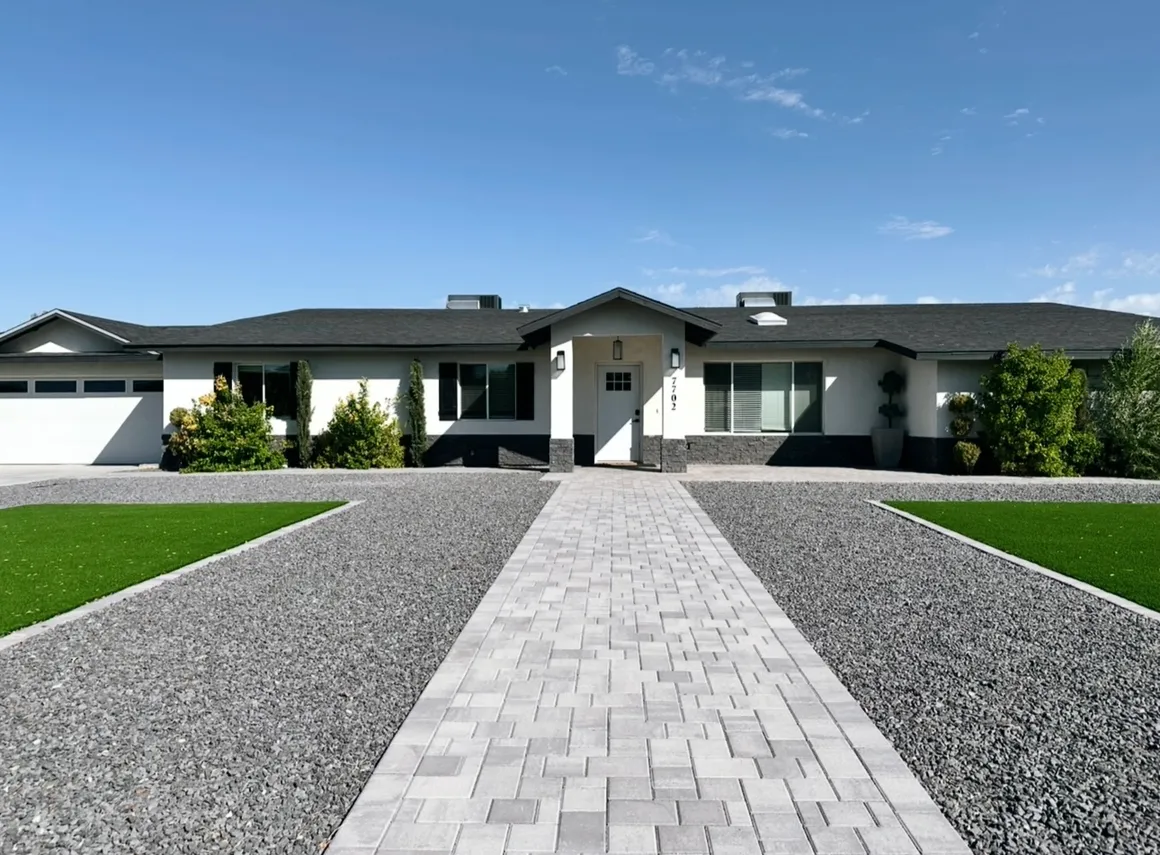Exterior of Encompass Senior Living home in Scottsdale — white ranch-style home with paver walkway and landscaping